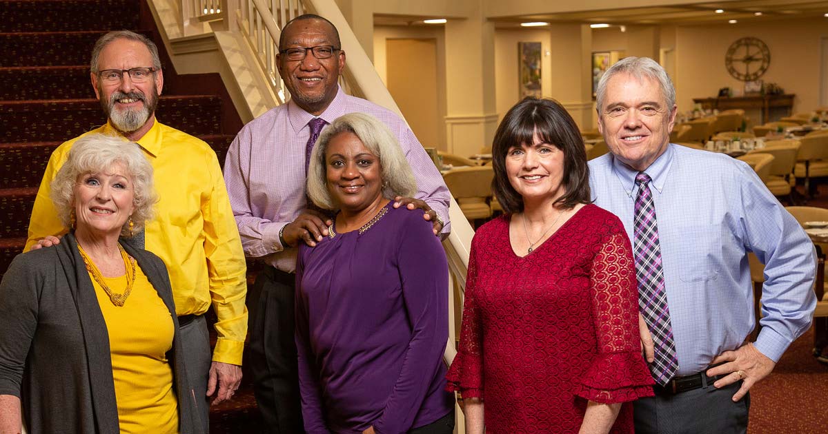 Hudson Estates staff members on stairs