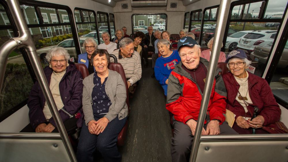 Hudson Estates happy seniors on a bus.
