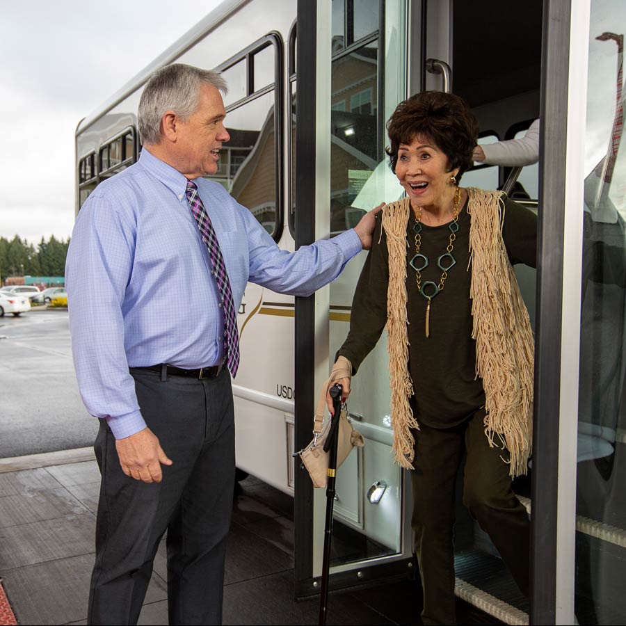 Hudson Estates helping lady off bus